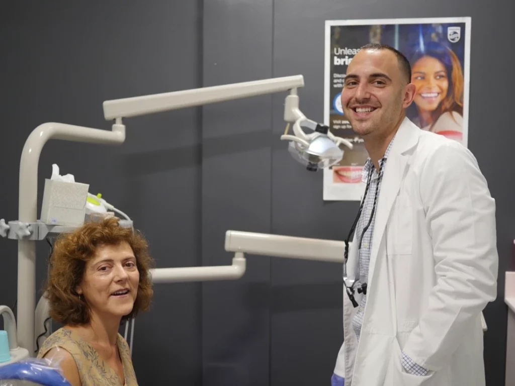 Dr. Andy Brito, DMD smiling with a patient at Brito Family Dental